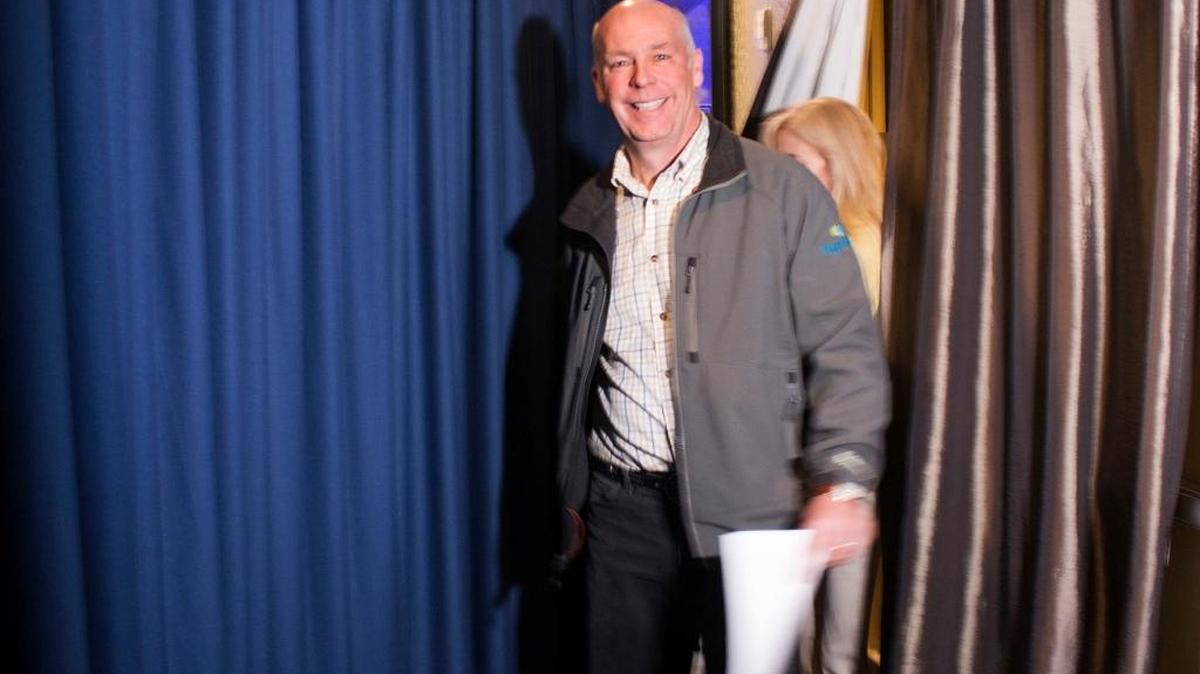 Republican Greg Gianforte prepares to go onstage at a hotel ballroom.