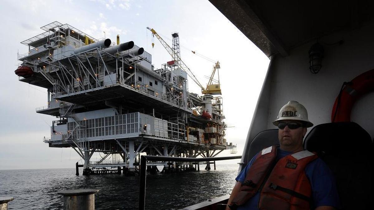 A crew member arrives by boat at offshore oil drilling platform 'Gail' operated by Venoco, Inc. off the coast of California near Santa Barbara, Calif.