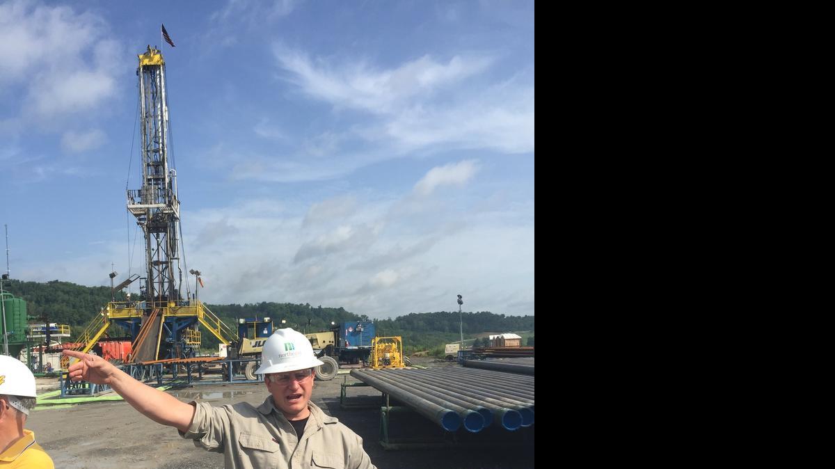 
Northeast Natural Energy drilling manager Jay Hewitt stands in front of a rig drilling top holes as part of the Marcellus Shale Energy and Environment Laboratory in Morgantown, W.Va. Part of the project is a search for life deep underground in the shale.
