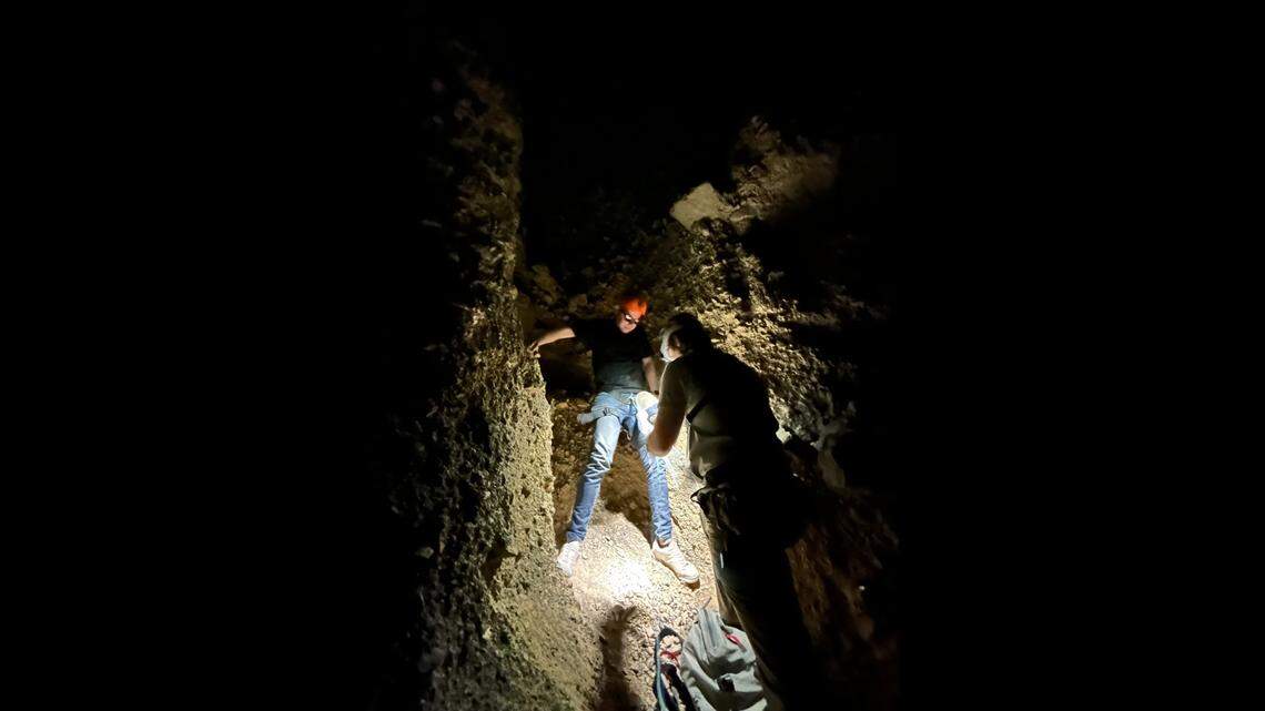 Park rangers are seen putting a harness on the hiker.