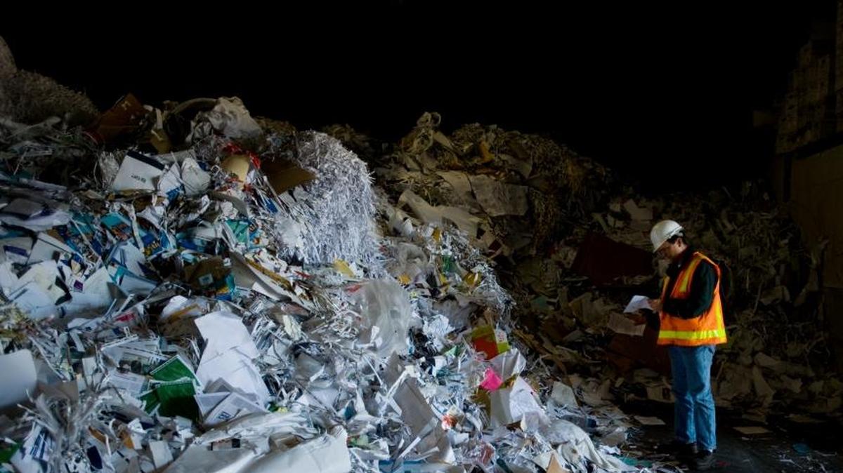 David Kuhnen, general manager of Recycling Industries in Sacramento, Calif., surveys a pile of scrap paper and other recycled material destined for China on Oct. 20, 2009. China this year has restricted imports of U.S. mixed paper and plastics, which are upsetting recycling markets but creating new opportunities.