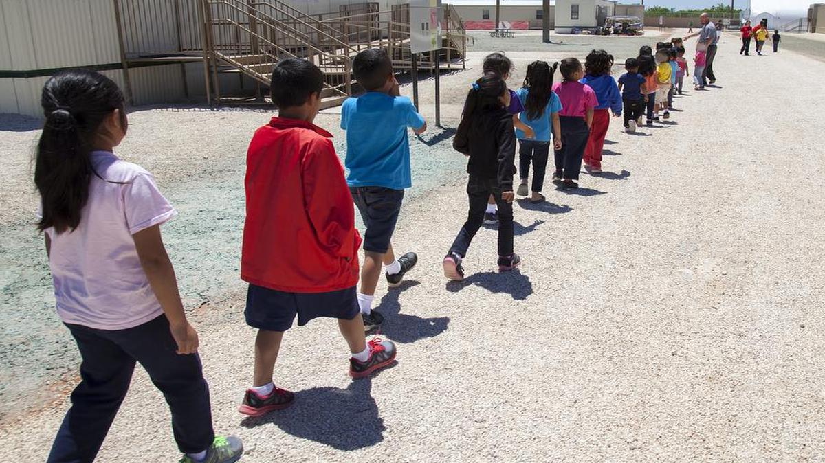 Children walk to class at the South Texas Family Residential Center in Dilley, Texas. Lawyers say more than 500 parents and children have been detained longer than is allowed by a court order.