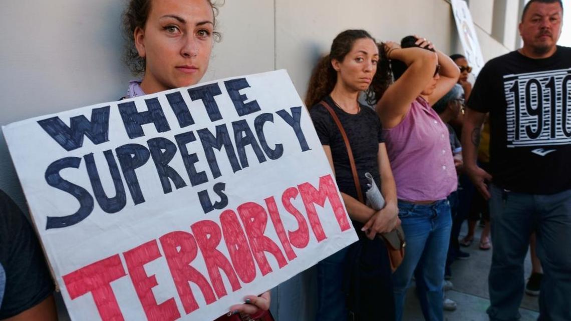 A demonstrators carrying signs protesting racism in Los Angeles last August, when many rallied to condemn racism in the wake of the deadly events in Charlottesville, Va.