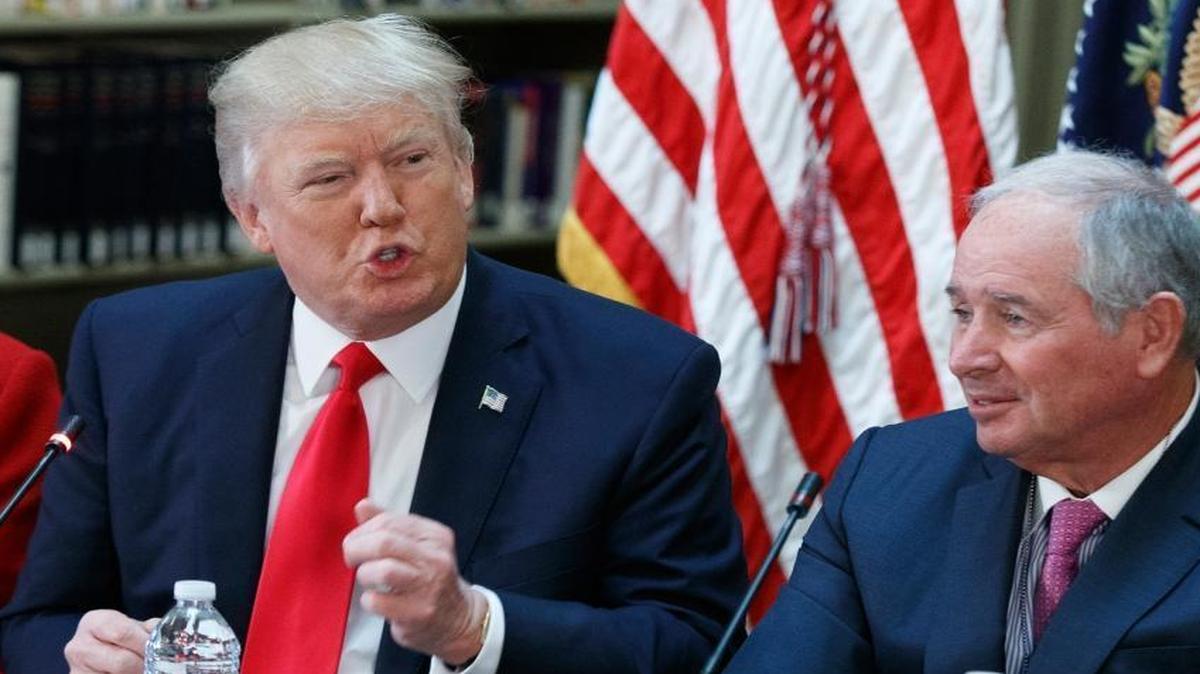 Blackstone Group CEO Stephen Schwarzman, an adviser to President Donald Trump, listens as Trump addresses a meeting with business leaders in the Eisenhower Executive Office Building in Washington, Tuesday, April 11, 2017. Schwarzman, who runs one of the world’s largest private equity funds, is one of several Trump allies who have financial stakes in infrastructure projects that could benefit from the White House’s actions.