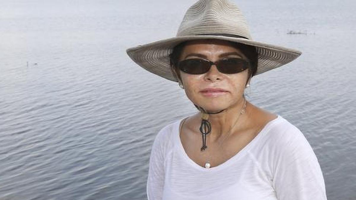 Olivia Lopez sits on the dock at her water-front home on Lake Corpus Christi in Lake City, Texas on July 24, 2015. Lopez says she'll forever be traumatized after at the Texas Family Detention Center. When she was hired, she expected a group home setting, but the clanging of the locks and gates as she went through security on her first day proved to her she was working at a "prison."