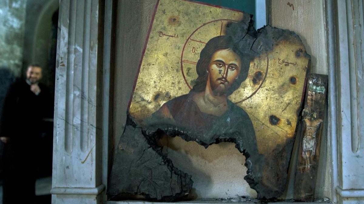 A half-burned image of Christ is placed next to a wall at a Greek Orthodox church in Maaloula, Syria, on Thursday, March 3, 2016. Maaloula, an ancient Christian town 40 miles northeast of Damascus, changed hands several times in the war. Its historic churches pillaged by jihadis and buildings riddled with shrapnel reflect fierce fighting that devastated the town two years ago.