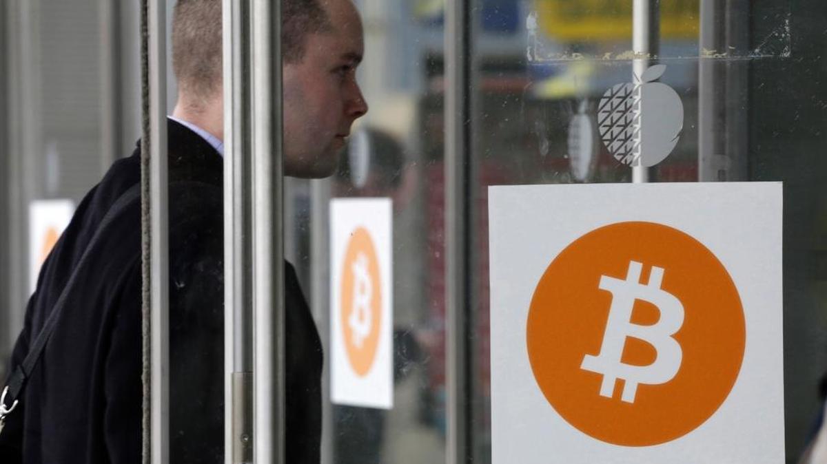 A man enters the Inside Bitcoins conference and trade show in New York in 2014. The bitcoin network is consuming more energy, and takes a heavy toll on power grids.