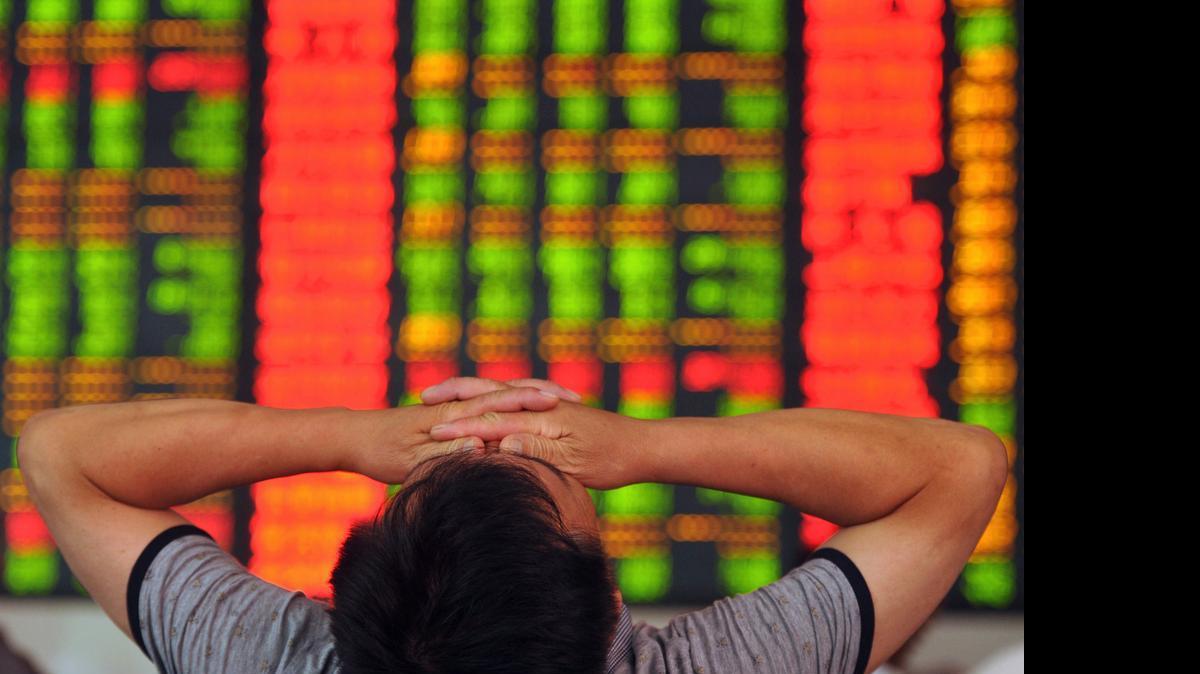 
A stock investor covers his eyes at a brokerage house in Fuyang in central China's Anhui province on July 8, 2015. China announced a flurry of new moves to halt a stock market slide.
