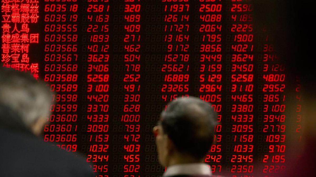 Chinese investors monitor stock prices at a brokerage house in Beijing, Friday, Jan. 29, 2016. Slower economic growth in China has cut its demand for steel and the coal used to make it.