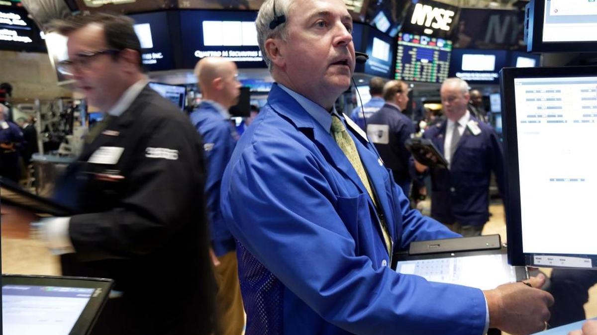 
Trader James Lamb, center, works on the floor of the New York Stock Exchange Thursday, Aug. 27, 2015. A report Friday showed that the U.S. economy expanded at a much faster pace than previously estimated. 
