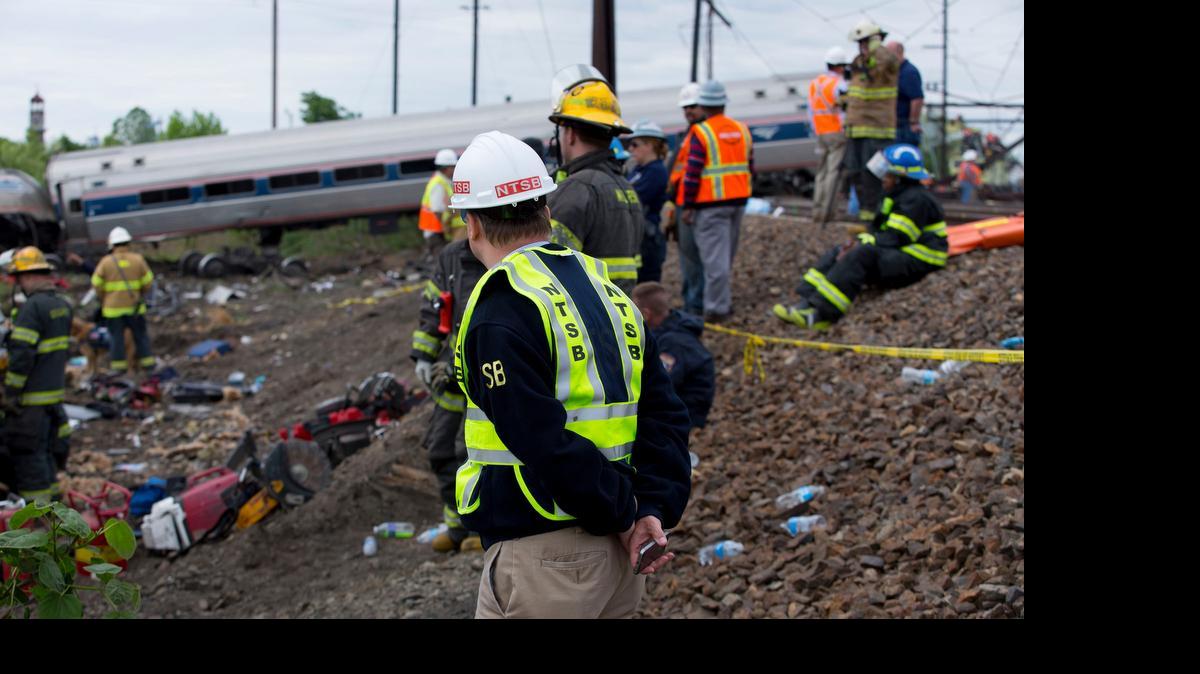 
Investigators from the National Transportation Safety Board examine the site of a May 12, 2015, Amtrak crash north of Philadelphia. The NTSB has recommended that Amtrak install inward-facing video and audio recorders in all of its locomotives and that the devices be crash- and fire-protected.

