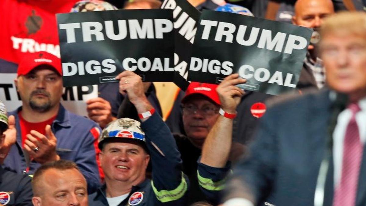 Coal miners wave signs as e Donald Trump speaks during a rally in Charleston, W.Va. Trump's election could signal the end of many of President Barack Obama's signature environmental initiatives. Trump has said he loathes regulation and wants to use more coal and expand offshore drilling and hydraulic fracturing. May 5, 2016.