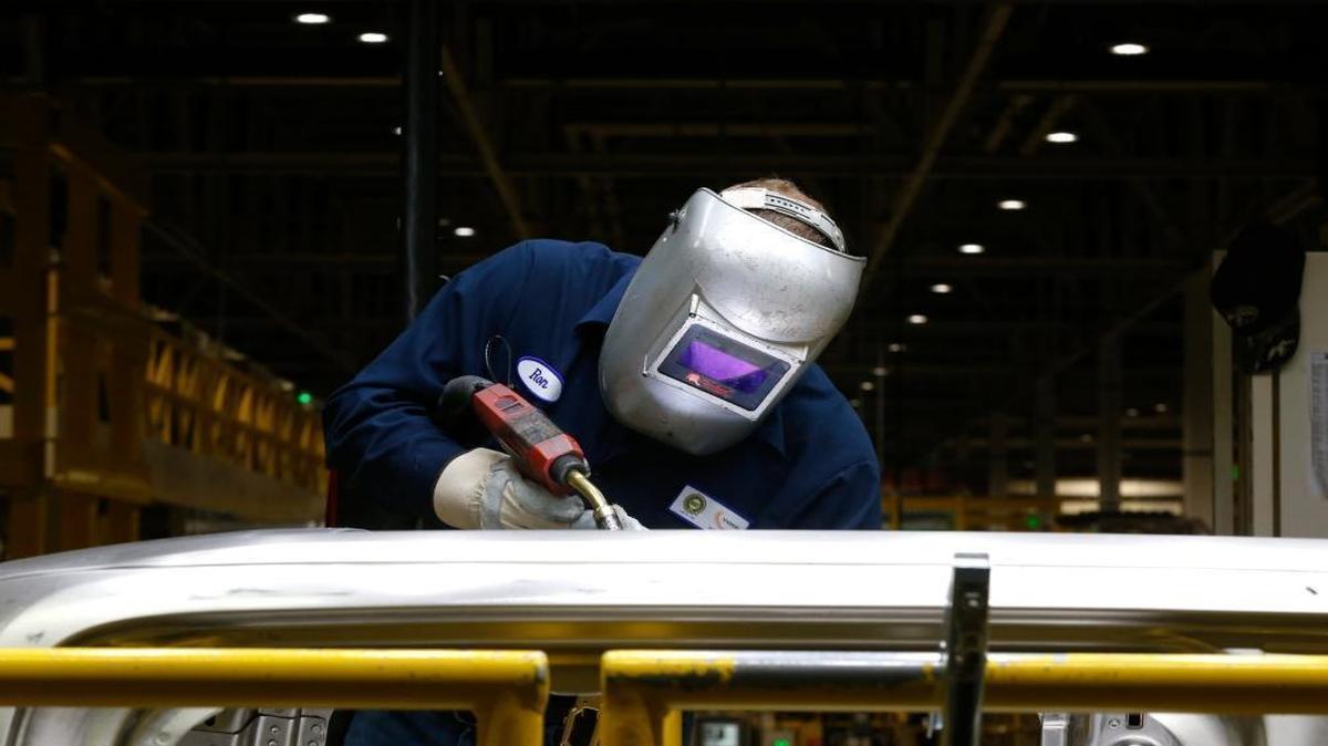 In this Nov. 11, 2014 photo, Ron Hudgins welds a 2015 Ford F-150 cab at the Dearborn Truck Plant in Dearborn, Mich.
