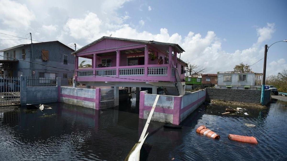 Homes in the Juana Matos community are surrounded by flood waters in Catano, Puerto Rico, one week after Hurricane Maria came through. Few in the territory were covered by flood insurance.