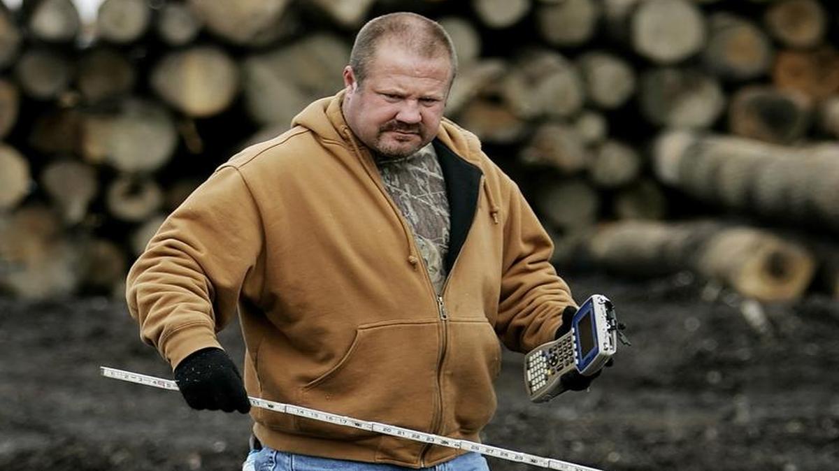 Tony Woodyard, co-owner of Twin River Hardwoods Inc., measures logs on Monday, March 10, 2008, at the sawmill in Southside, W.Va.
