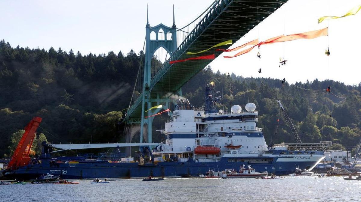 
The Royal Dutch Shell PLC icebreaker Fennica heads up the Willamette River under protesters hanging from the St. Johns Bridge on its way to Alaska in Portland, Ore. on July 30, 2015. Royal Dutch Shell will cease exploration in Arctic waters off Alaska's coast following disappointing results from an exploratory well backed by billions in investment and years of work. The announcement that came on Monday, Sept. 28, was a huge blow to Shell, which was counting on offshore drilling in Alaska to help it drive future revenue. Environmentalists, however, had tried repeatedly to block the project and welcomed the news. 
