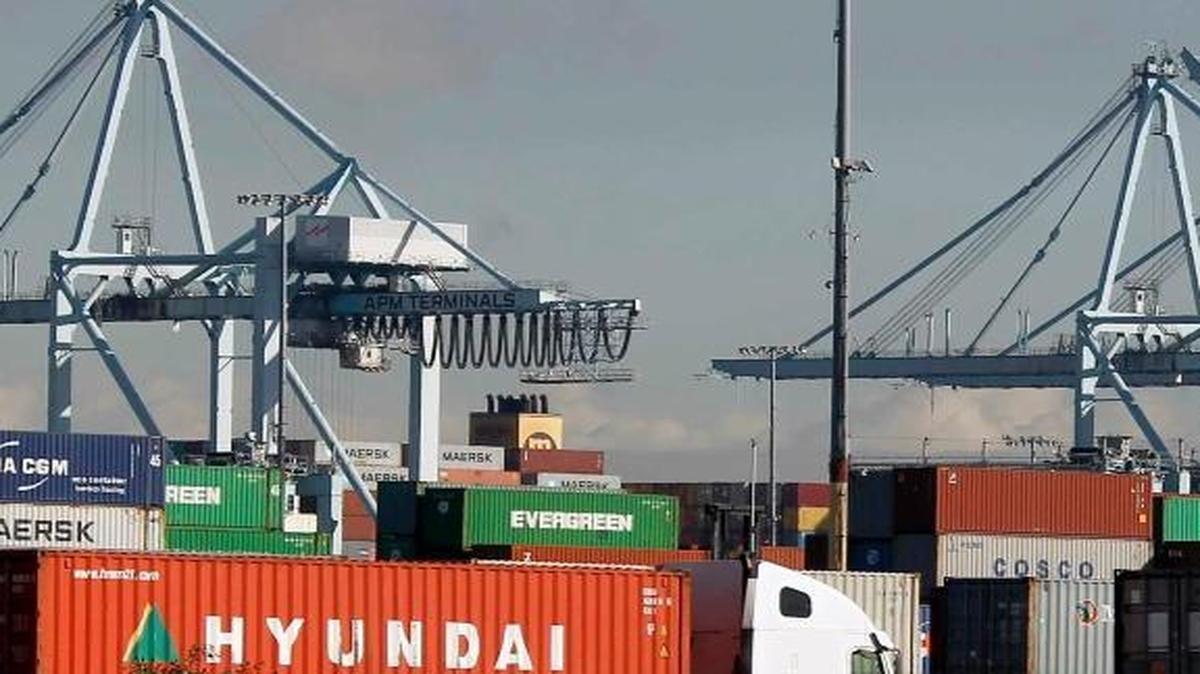 Trucks hauling containers on Thursday leave the Port of Los Angeles, the busiest container port in the Western Hemisphere, moving about $1.2 billion worth of cargo in and out each day.