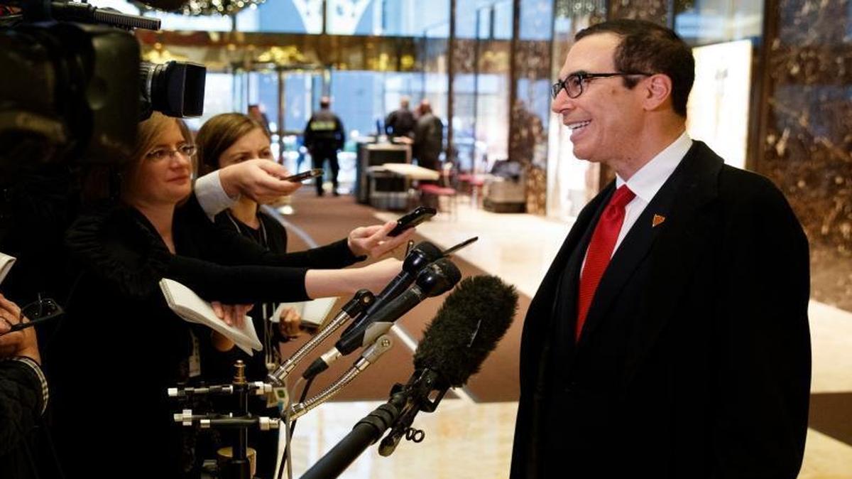 Steven Mnuchin, President-elect Donald Trump's nominee for Treasury Secretary, talks with reporters in the lobby of Trump Tower, Wednesday, Nov. 30, 2016, in New York.