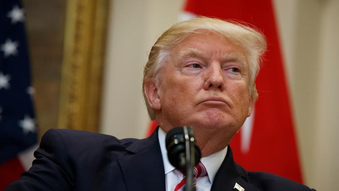 President Donald Trump listens as Turkish President Recep Tayyip Erdogan speaks in the Roosevelt Room of the White House.