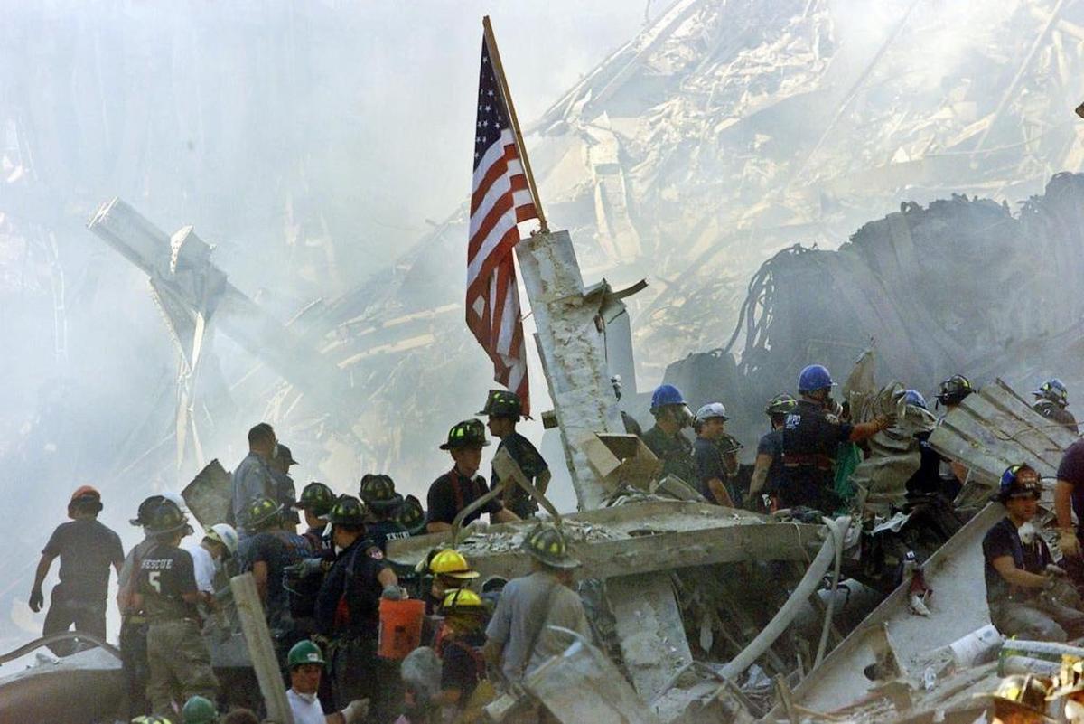 Rescuers search through the rubble at the World Trade Center two days after the attacks on Sept. 11, 2001.