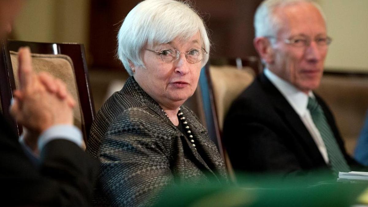 
In this July 20, 2015, file photo, Federal Reserve Chair Janet Yellen, from left, with Vice Chairman Stanley Fischer, and the board of governors of the Federal Reserve System, presides over a meeting in Washington. Nine years after they last raised their benchmark interest rate and after months of feverish speculation, Federal Reserve policymakers this week may finally raise that rate from a record low near zero.
