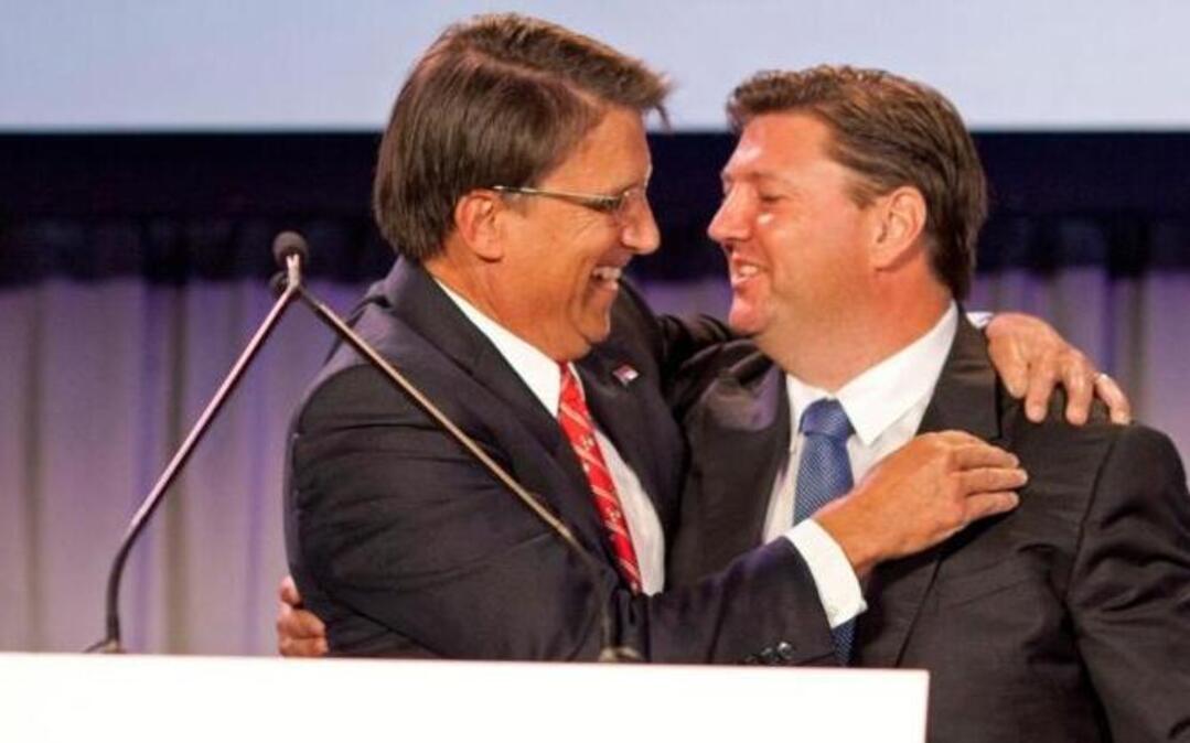 North Carolina Gov. Pat McCrory, left, embraces Norwegian entrepreneur Jostein Eikeland, founder, chairman and CEO of Alevo Group, during the Alevo Energy global launch and manufacturing facility opening in Concord, N.C., Oct. 28, 2014.