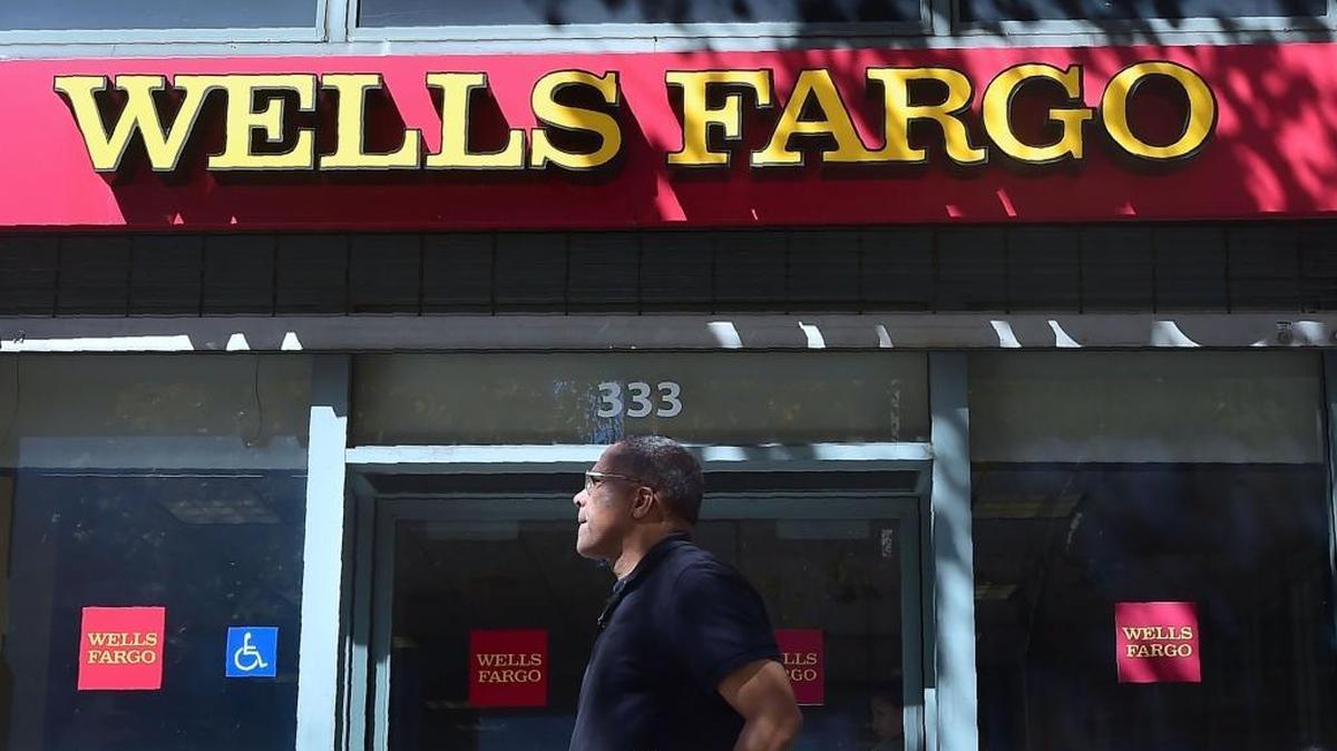 A customer walks by a Wells Fargo branch.