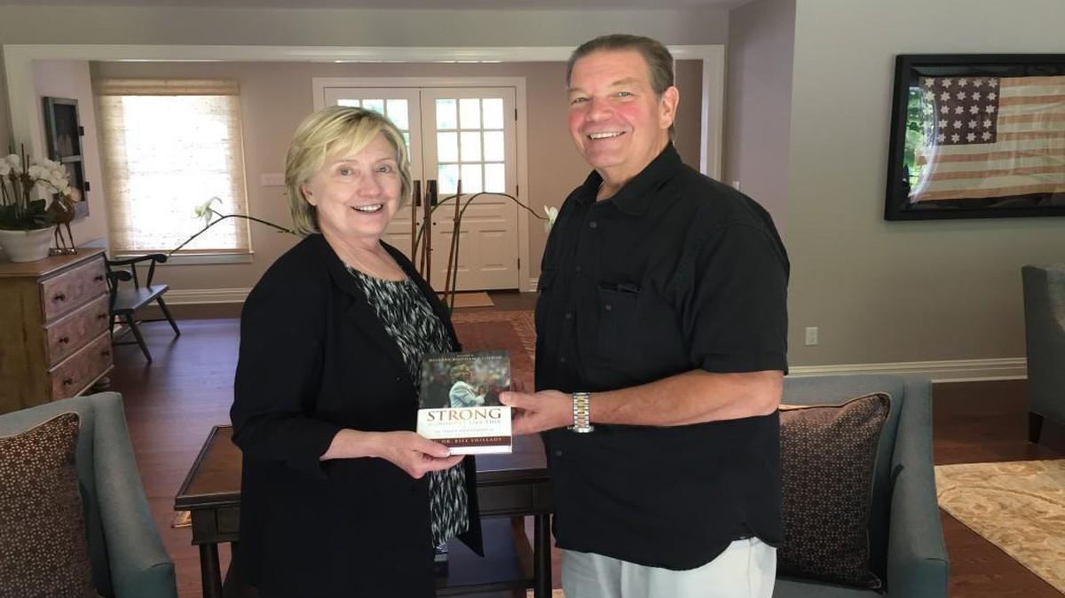 Hillary Clinton and the Rev. Bill Shillady with “Strong for a Moment Like This,” a book of devotionals Shillady and others wrote for Clinton during the 2016 presidential campaign.