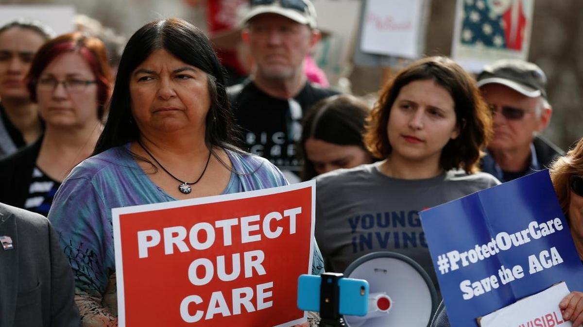 State Sen. Dr. Irene Aguilar, D-Denver, left, stands with health care activist Christina Postolowski of the group, Young Invincibles, during a rally at the state capitol in Denver to support the Affordable Care Act on Jan. 31, 2017. A new analysis says the Republican legislation to replace the ACA would cause 1.8 milion job losses in 2022. (AP Photo/Brennan Linsley)