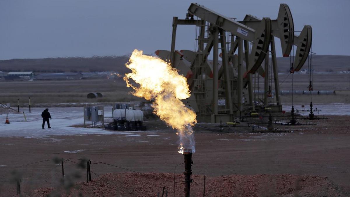 Methane is burned off in front of oil pump jacks in Watford City, N.D., on Oct. 22, 2015. In early July, a federal court blocked the Trump administration from delaying Obama-era rules aimed at reducing releases of methane, a potent greenhouse gas, from oil wells and refineries. The ruling was in response to one of scores of lawsuits filed against Trump’s environmental decisions since Jan. 22.