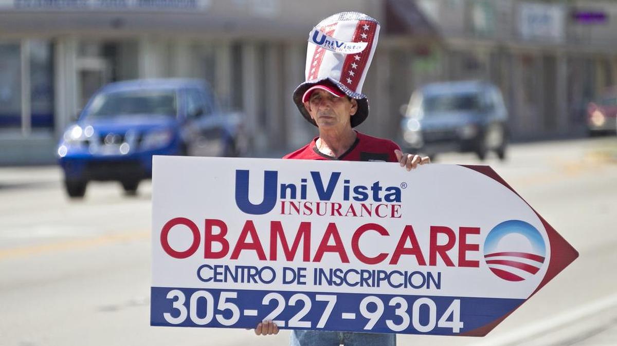 In this 2015 photo, a man advertises Affordable Care Act Coverage in Miami. The Obama administration on Tuesday reported for the first time demographic information for consumers who have signed up for coverage on the Affordable Care Act exchange at healthcare.gov. More than 1.6 million Floridians signed up for coverage as of Dec. 24.