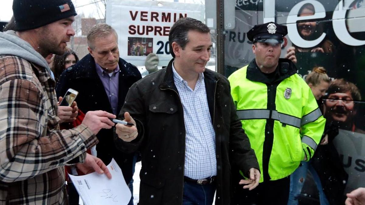 Republican presidential candidate, Sen. Ted Cruz, R-Texas, (center) walks toward his bus after a campaign event, Monday, Feb. 8, 2016, in Manchester, N.H.