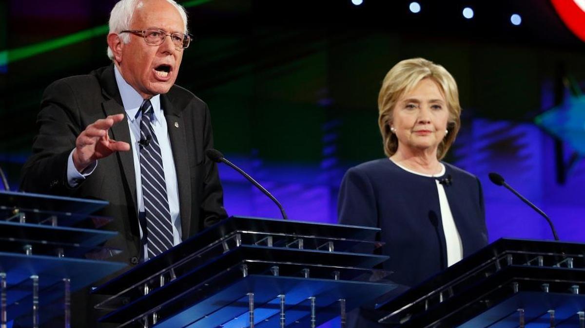 
Hillary Rodham Clinton, right, looks on as Sen. Bernie Sanders, of Vermont, speaks during the CNN Democratic presidential debate Tuesday, Oct. 13, 2015, in Las Vegas. 
