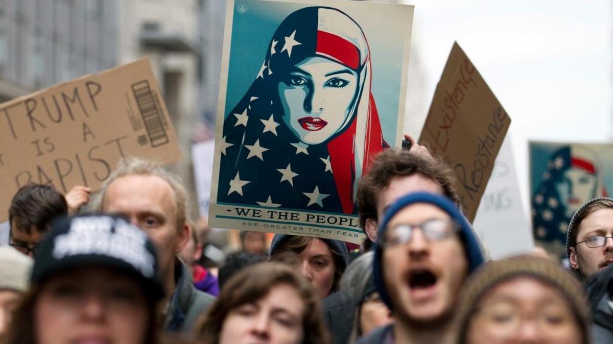 Teachers were asked to remove posters from Shepard Fairey’s “We the People” series from their classrooms. One of the images is seen here in a women’s march protest.