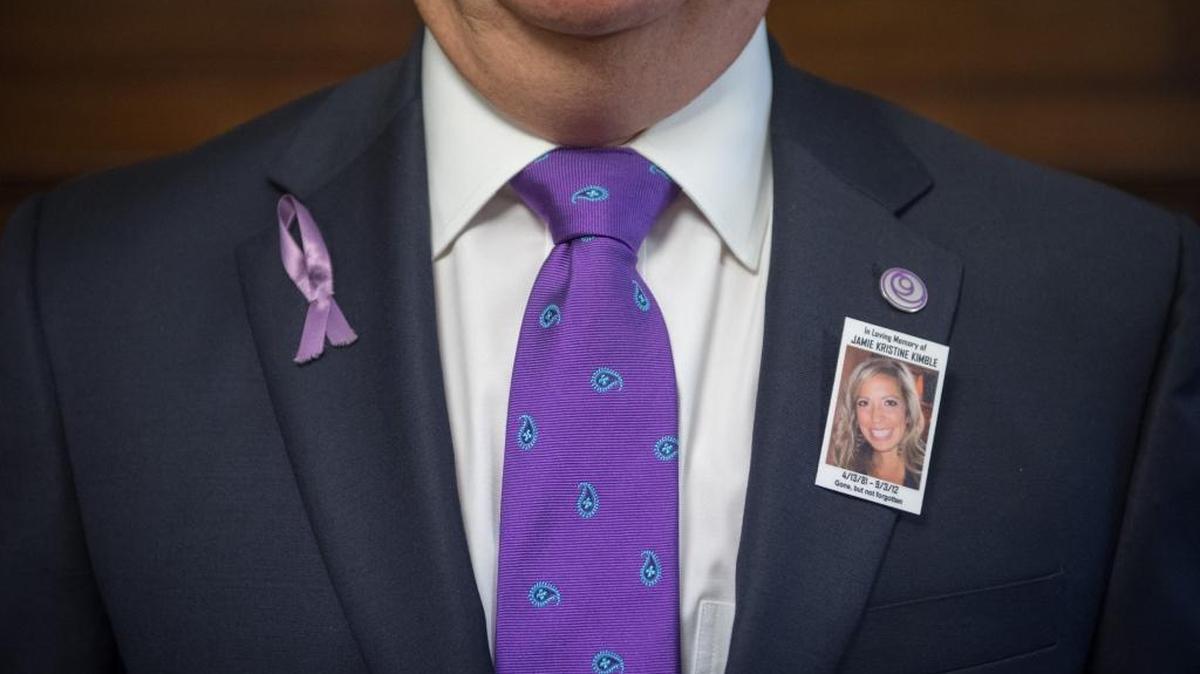 Charlotte's deputy city manager Ron Kimble proudly displays a photo of his daughter Jamie Kimble on his lapel as he listens to Congresswoman Alma Adams, D-N.C., speak on the issue of domestic violence while on Capitol Hill, in Washington, D.C., Oct. 28, 2015. Kimble's daughter Jamie Kristine Kimble was 31 when she was shot and killed by her ex-boyfriend. Kimble shared his family story while pressing members of Congress to support stronger legislation to stop domestic violence.