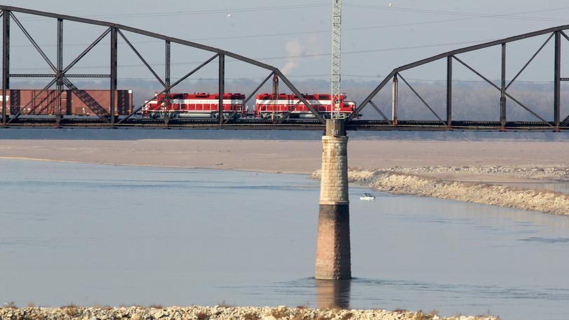 The Merchants railroad bridge over the Mississippi River at St. Louis was built in 1890, and its truss spans need to be replaced. Only one train at a time can cross the two-track bridge, and they creep across it at 5 mph.