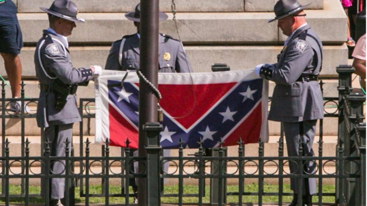 The SC Highway Patrol Honor Guard removes the Confederate flag from the State House grounds in Columbia, S.C> during a ceremony in July 2015.