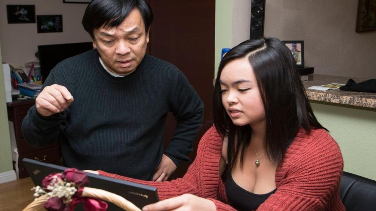 Hank Nguyen and his daughter Audrey Nguyen in their Dublin, California, home. Nguyen is among the UCSF IT workers about to lose his job.
