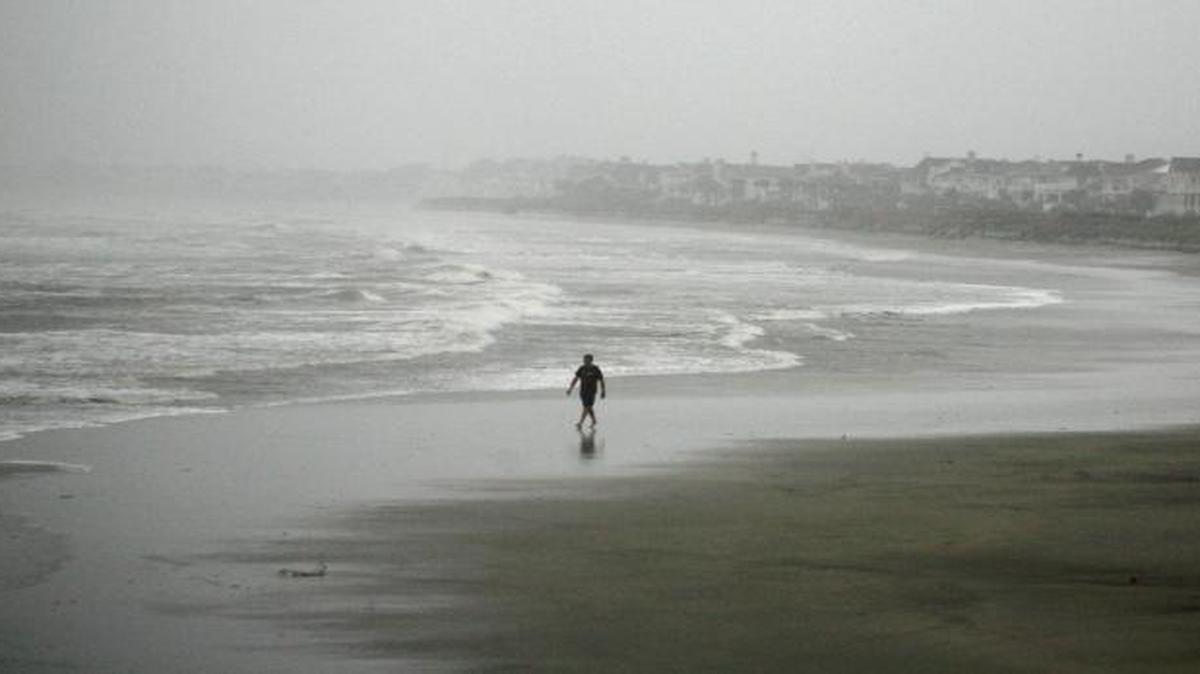 Most recent coastal nuisance flooding has been the result of sea level rise, a new study indicates. In this photo, Robert Nicotra braves the wind and rain along the beach on the Isle of Palms, S.C., as Hurricane Matthew approaches on Oct. 7, 2016.