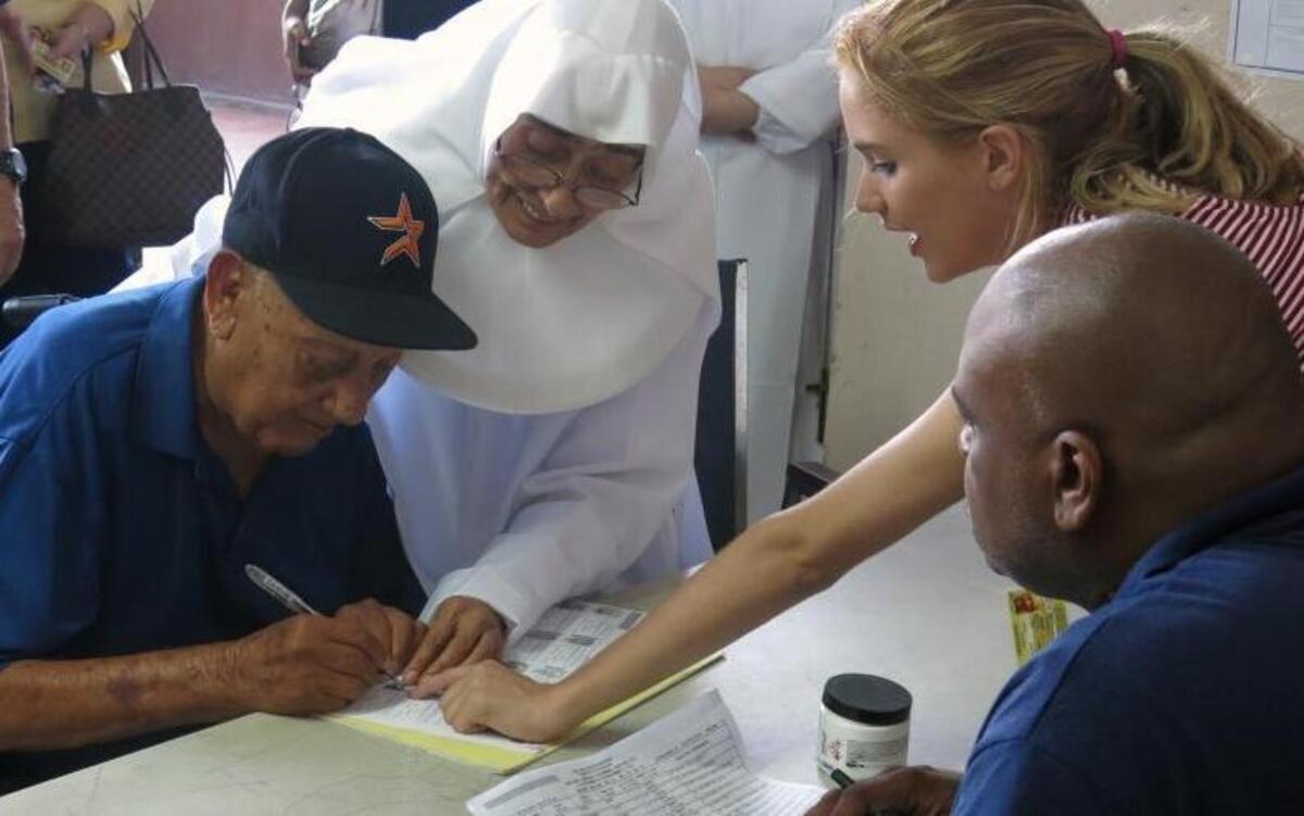 A voter signs in at a polling station to vote in the general election at an elementary school in San Juan, Puerto Rico, Tuesday, Nov. 8, 2016. Residents of Puerto Rico are U.S. citizens, but they can’t vote in the U.S. presidential election. The residents will vote June 11, 2017, on full U.S. statehood, but many say the timing couldn’t come at a worse time for the struggling island.