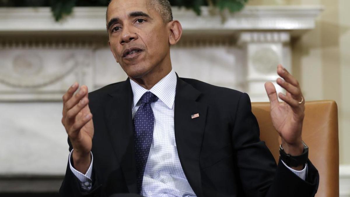 FILE - In this Oct. 21, 2016, photo, former President Barack Obama speaks to media in the Oval Office of the White House in Washington. In total, Obama commuted 1,715 sentences, mostly for drug offenders.