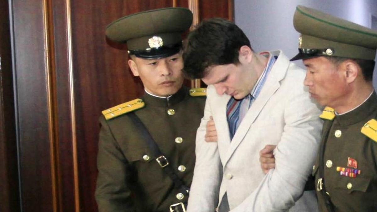 Guards escort American student Otto Warmbier at the Supreme Court in Pyongyang, North Korea on March 16, 2016. Warmbier, whose parents say has been in a coma while serving a 15-year prison term in North Korea, was released and returned to the United States on Tuesday, June 13, 2017.
