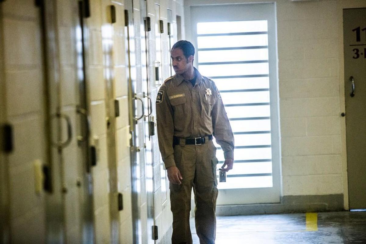 A corrections officer performs a cell check at the Durham County jail.