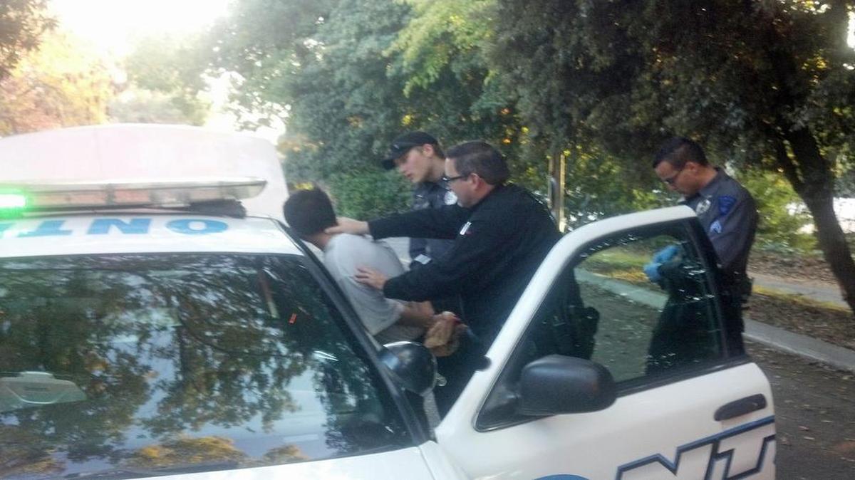 Jose Cruz, 21, is taken into custody, accused of burglarizing a home in Modesto, Calif., on Saturday, Nov. 21, 2015.