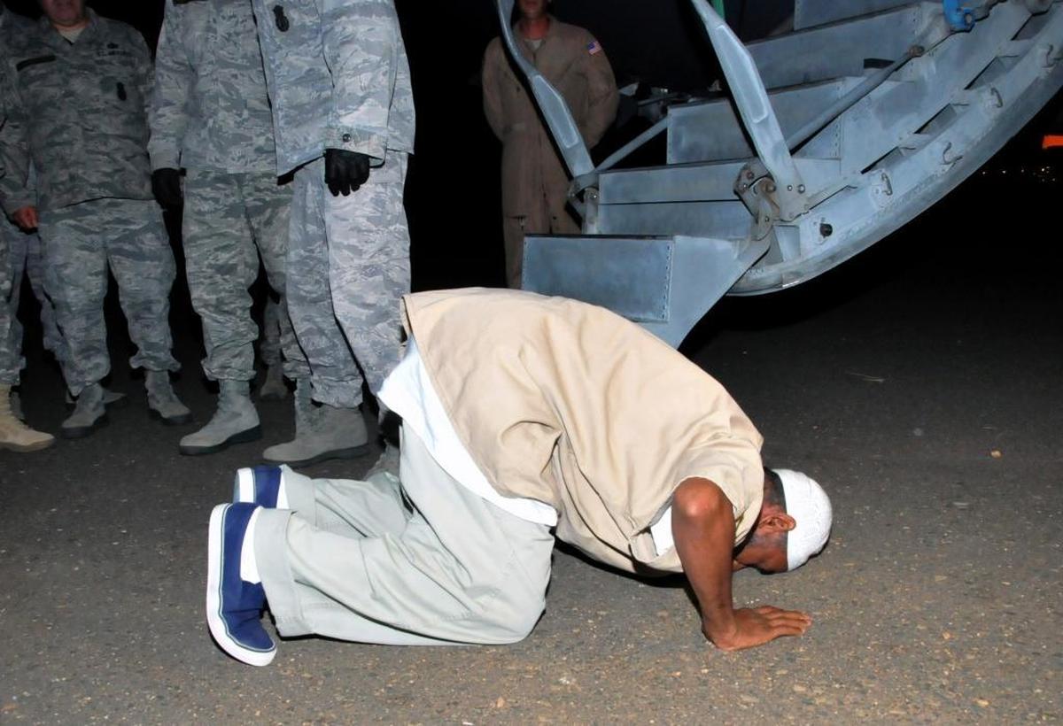 Sudanese national, Ibrahim al-Qosi, in his 50s, a former al-Qaida cook released from Guantánamo, prays upon arrival at Khartoum airport in Sudan, July 11, 2012. Al-Qosi arrived before dawn on a U.S. Air Force plane after his release from 10 years in detention.