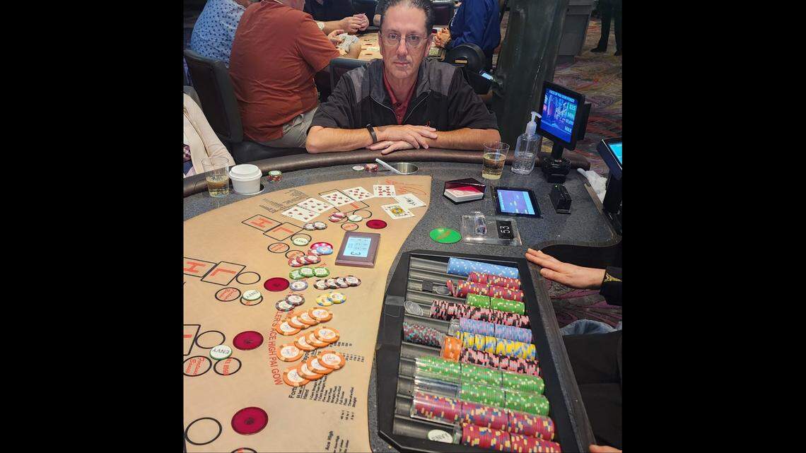 The lucky poker player is pictured with his winning cards: 5, 6, 7, 8, 9, joker and a jack.