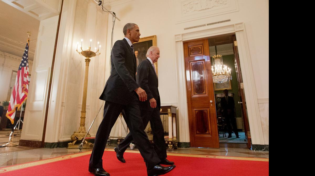 
President Barack Obama walks with Vice President Joe Biden, after delivering remarks in the East Room of the White House in Washington, Tuesday, July 14, 2015, after an Iran nuclear deal is reached. 
