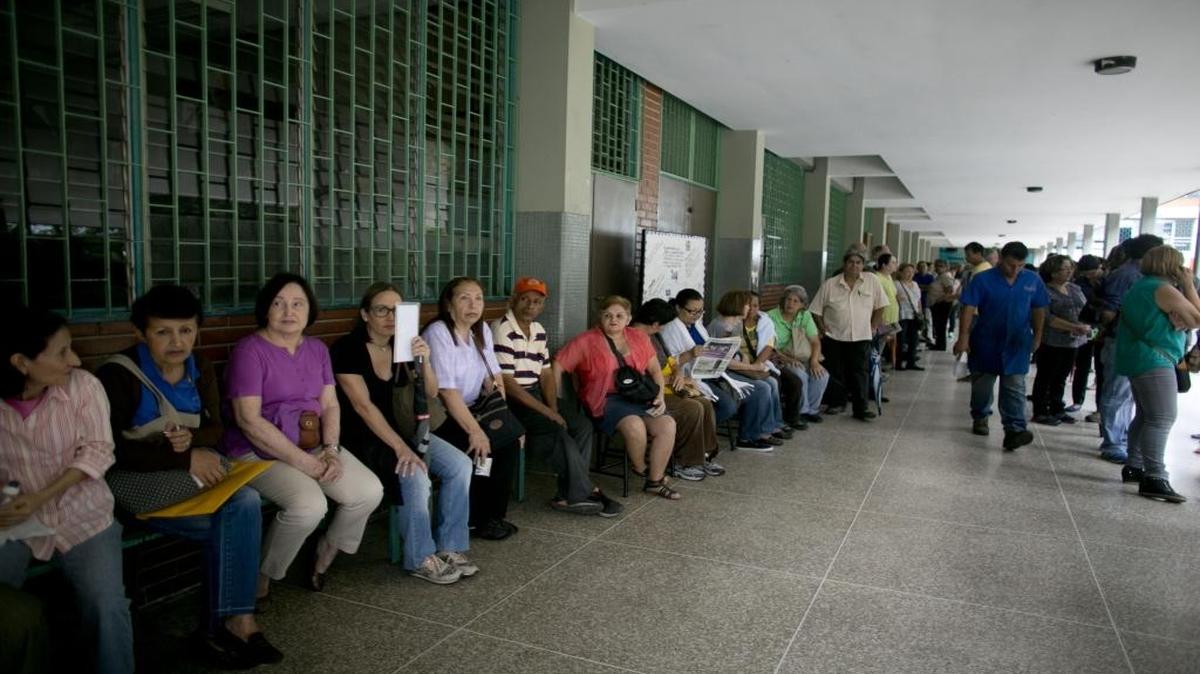 People line up inside of a school set up as a validation center to certify the authenticity of their signatures in Caracas, Venezuela, on Monday, June 20, 2016. Venezuela starts a crucial stage in the possible recall referendum against President Nicolas Maduro with the validation of 1.3 million signatures supporting the referendum.