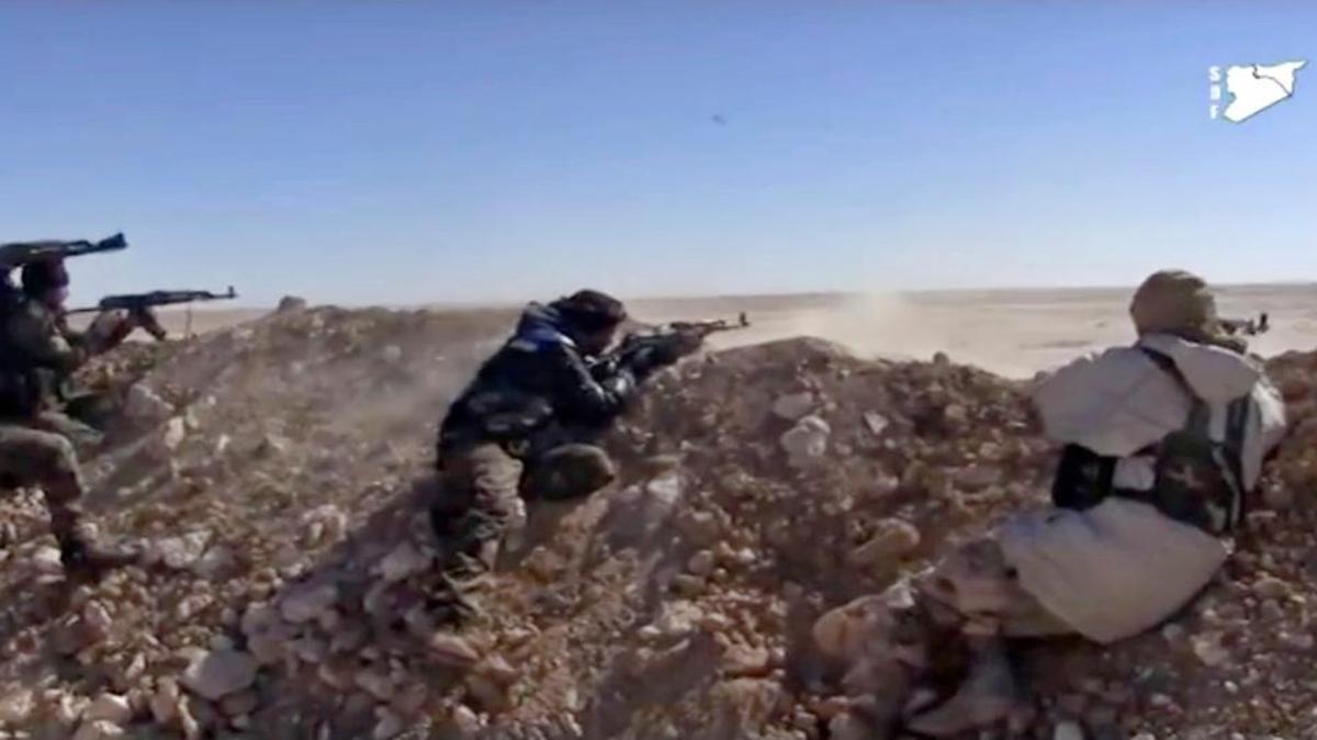 This frame grab from a video provided by the Syrian Democratic Forces purports to show their fighters opening fire on an Islamic State position in the countryside east of Raqqa in early March.