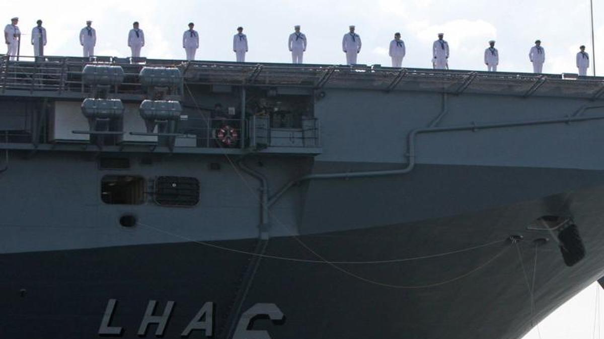 Sailors stand on deck as the USS America LHA6 leaves Ingalls Shipbuilding in Pascagoula, Miss., on Friday, July 11, 2014. Ingalls officials went to a symposium near the Pentagon this week to tout their shipbuilding prowess.